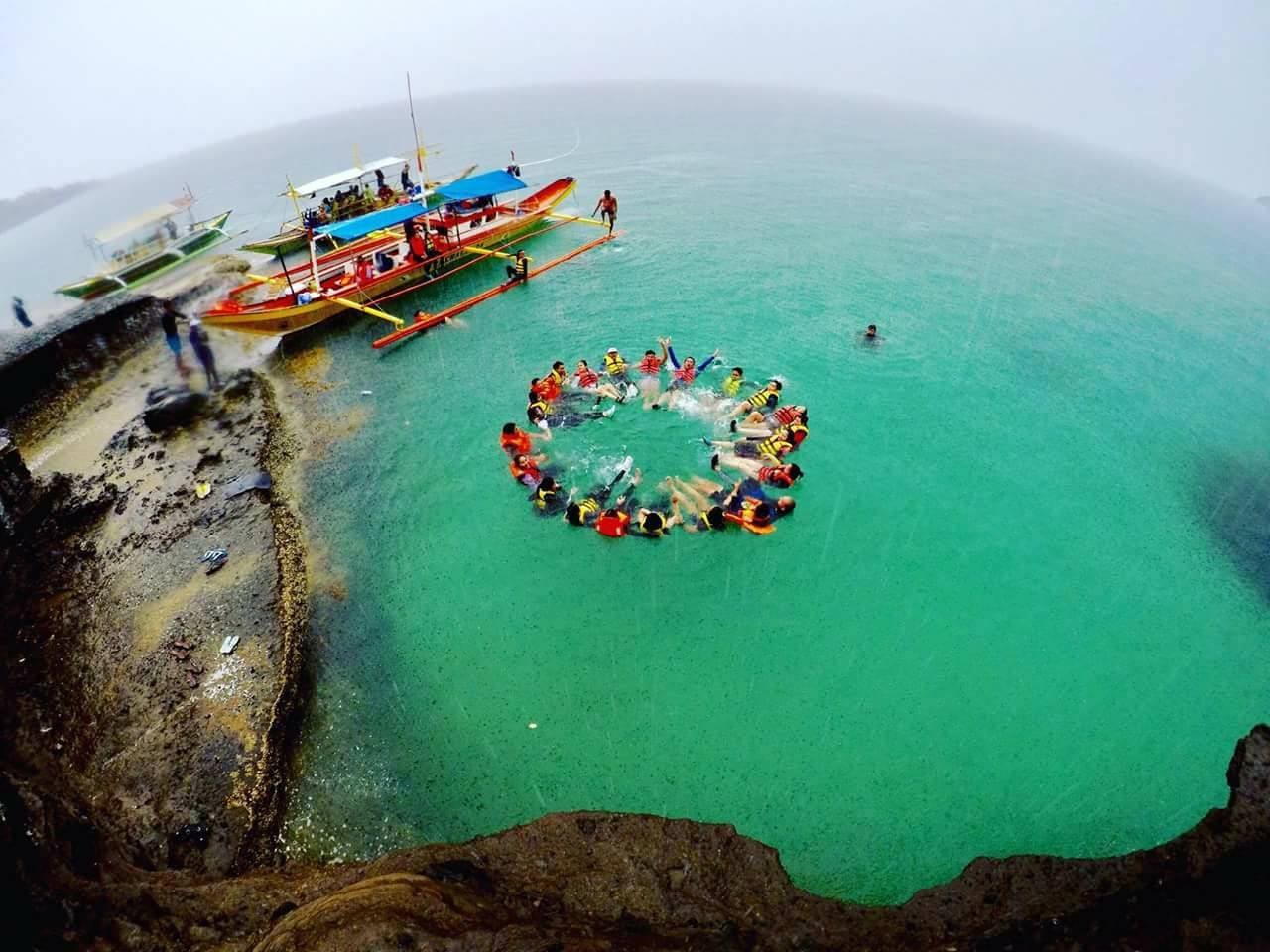 Picture of people forming a circle in the sea, Emerald Resort Tour